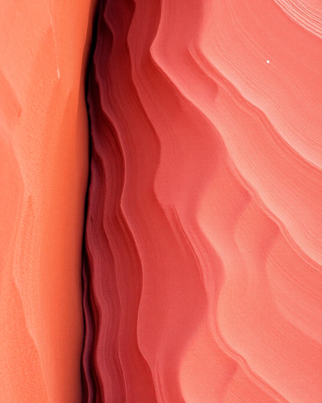 Close-up of wind-worn red sandstone wave patterns